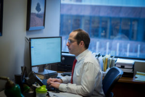 David Robbins, Attorney at Meyer Njus Tanick, looking at computer screens