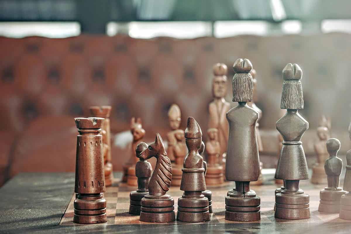 Chess pieces with leather furniture in background