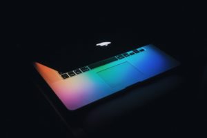 Macbook laptop with rainbow-colored lighting